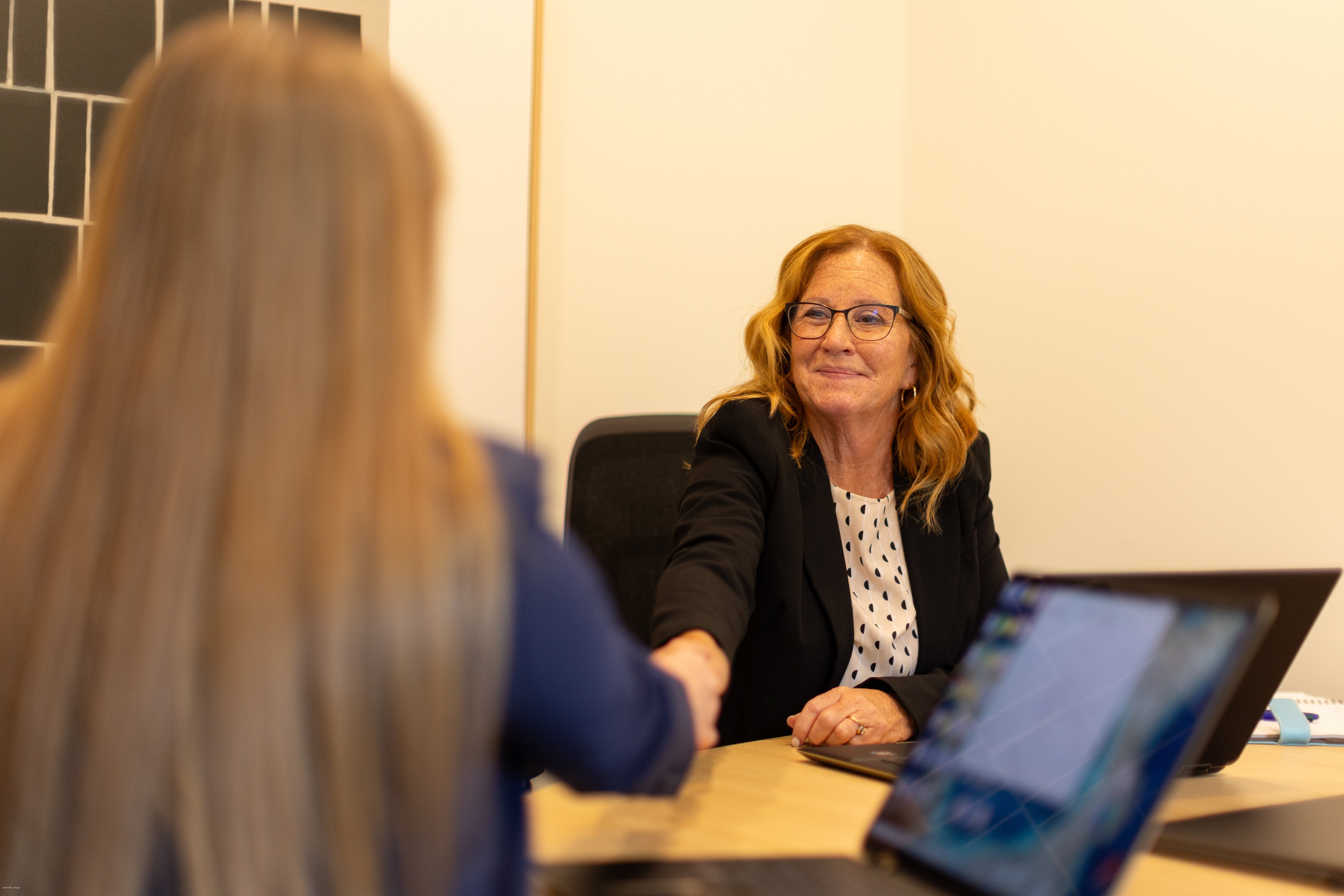 Happy client shaking hands with with an attorney